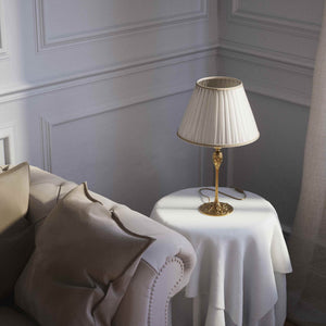 Art Nouveau table lamp Simona collection with decorated brass base featuring floral motifs and pleated ivory white fabric lampshade by Ghidini 1849 - Finish: OBS Bronze Satin Brass