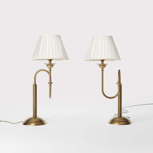 Brass table lamp with trombone-style design, ivory pleated shade, adjustable arm and decorated base, musical design Made in Italy by Ghidini 1849 - Finish: OBS Bronze Satin Brass
