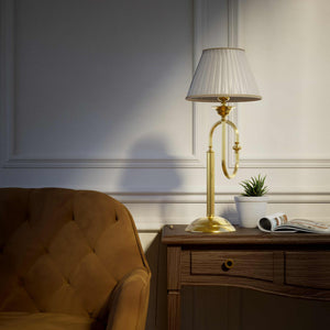 Brass table lamp with trombone-style design, ivory pleated shade, adjustable arm and decorated base, musical design Made in Italy by Ghidini 1849 - Finish: OLV Polished Brass