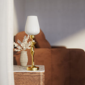 Art Deco table lamp with sculptural brass female figure and conical glossy white glass shade, decorative base by Ghidini 1849 - Finish: OLV Polished Brass