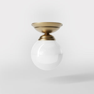 Classic ceiling light with glossy white glass globe and circular brass base elegant Italian design interior lighting by Ghidini 1849 - Finish: OBS Bronze Satin Brass