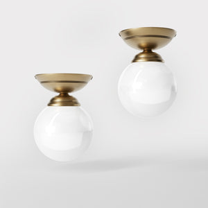 Classic ceiling light with glossy white glass globe and circular brass base elegant Italian design interior lighting by Ghidini 1849 - Finish: OBS Bronze Satin Brass