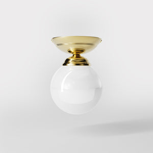 Classic ceiling light with glossy white glass globe and circular brass base elegant Italian design interior lighting by Ghidini 1849 - Finish: OLV Polished Brass