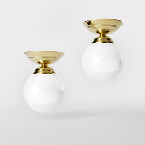Classic ceiling light with glossy white glass globe and circular brass base elegant Italian design interior lighting by Ghidini 1849 - Finish: OLV Polished Brass