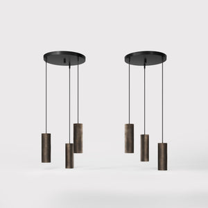 Modern pendant lamp with three brass cylinders and round matte black iron base, height-adjustable pendants, Venere design collection by Ghidini 1849 - Finish: OBM Bronze Satin Matt Brass
