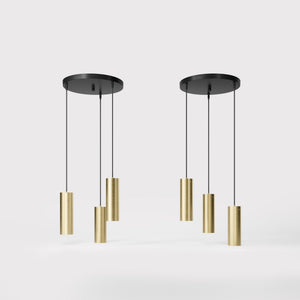 Modern pendant lamp with three brass cylinders and round matte black iron base, height-adjustable pendants, Venere design collection by Ghidini 1849 - Finish: OBV Bronze Satin Light Brass