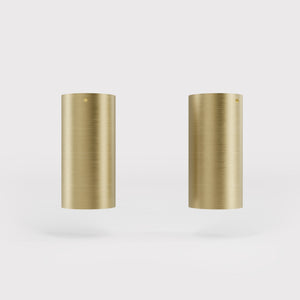 Cylinder ceiling lamp in brass with compact body installed on the ceiling of an elegant corridor by Ghidini 1849 - Finish: OBV Bronze Satin Light Brass