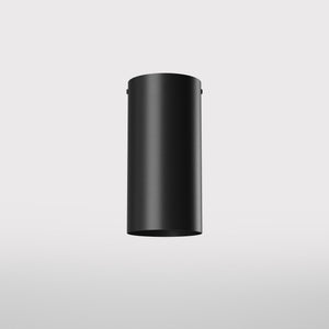 Cylinder ceiling lamp in brass with compact body installed on the ceiling of an elegant corridor by Ghidini 1849 - Finish: ONO Matt Black