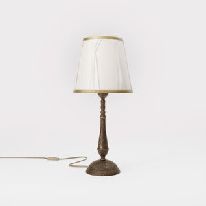 Classic brass table lamp with ivory fabric shade and decorative trims, round base and turned stem by Ghidini 1849 - Dimension/Finish: Medium / OAS Antique Brass