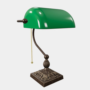 Banker’s lamp in brass with green glass shade, decorative base, and pull-chain switch. Elegant desk or decorative lighting by Ghidini 1849 - Finish: OAS Antique Brass