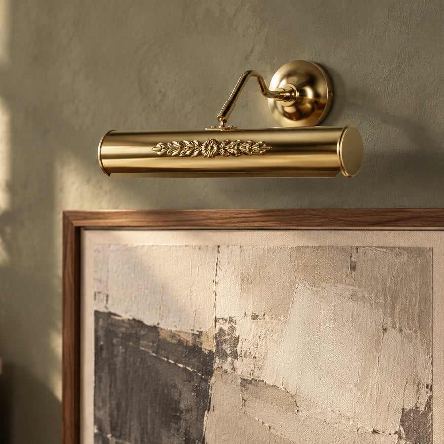 Polished-brass floral picture light above a walnut-framed abstract artwork on a sage wall