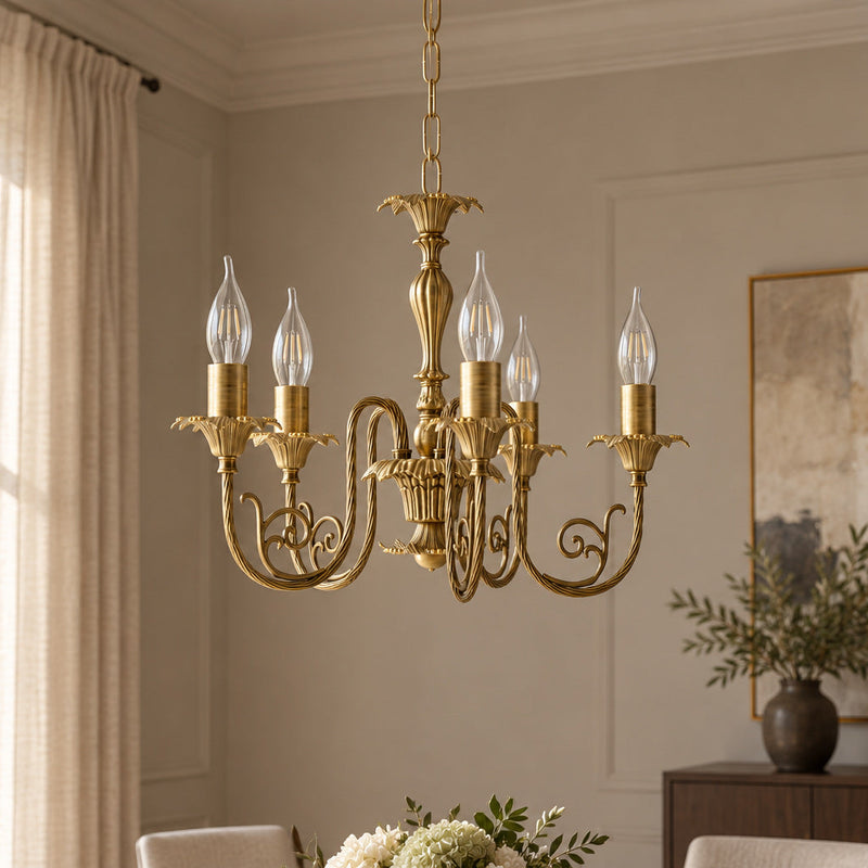 Luigi XV five-arm brass chandelier with clear candle bulbs in a contemporary dining room with tall windows and dark timber furniture.