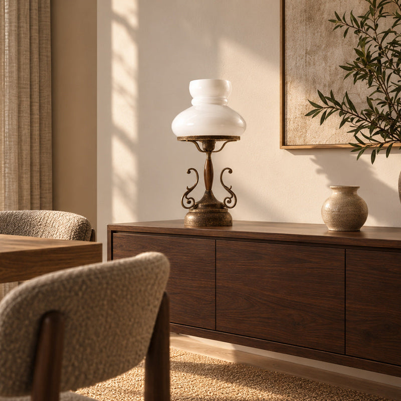 Mississippi antique brass table lamp with a white glass shade on a walnut sideboard in a sunlit dining room.