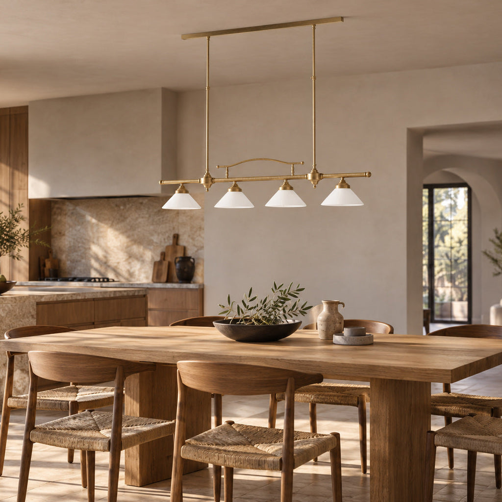 Sofia linear brass pendant with four white conical glass shades above a timber kitchen table.