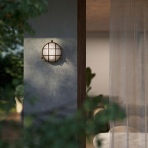 Round outdoor wall lamp in brass with protective grid and glass, marine style for outdoor lighting by Ghidini 1849 - Finish: OAS Antique Brass