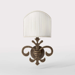 Baroque brass wall lamp with fleur-de-lis motif and decorative scrolls, ivory pleated shade, elegant classic style Made in Italy - Finish: OAS Antique Brass