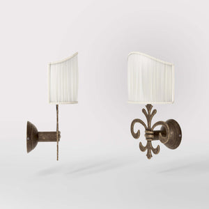 Baroque brass wall lamp with fleur-de-lis motif and decorative scrolls, ivory pleated shade, elegant classic style Made in Italy - Finish: OAS Antique Brass