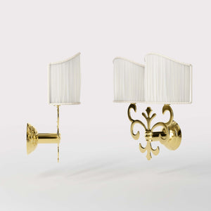 Neoclassical twin brass wall lamp with fleur-de-lis motif and symmetrical scrolls, white pleated shades, elegant Italian design - Finish: OLV Polished Brass