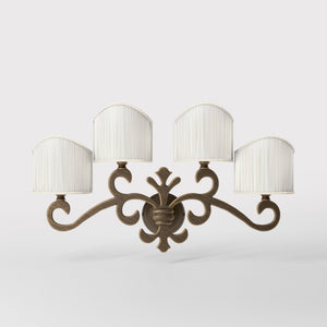 Classical four-light brass wall lamp with central fleur-de-lis and decorative scrolls, white pleated shades, refined Italian design - Finish: OBM Bronze Satin Matt Brass