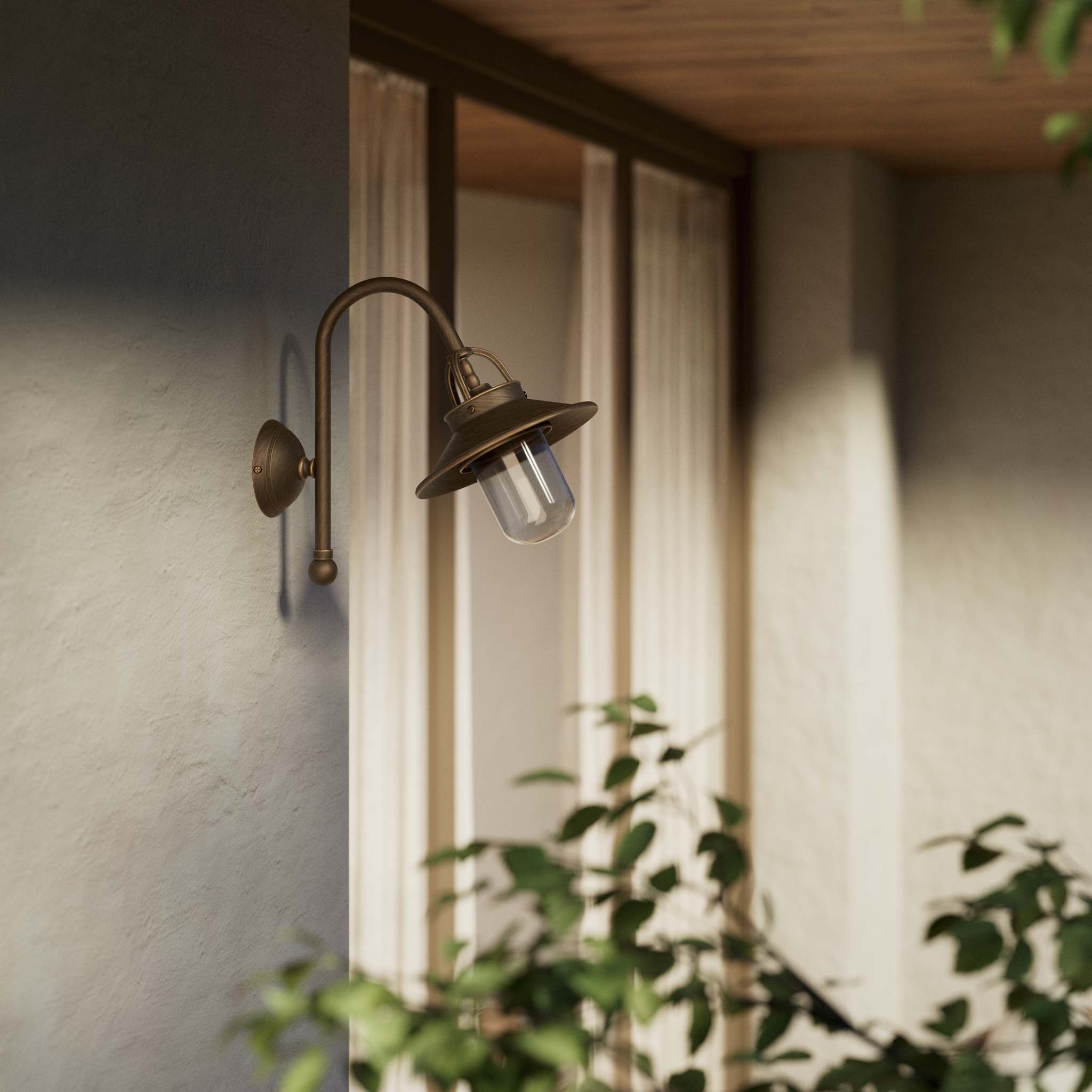 Outdoor brass wall lamp with curved arm protective hood and transparent glass diffuser rustic style Giada collection by Ghidini 1849 - Finish: OBM Bronze Satin Matt Brass