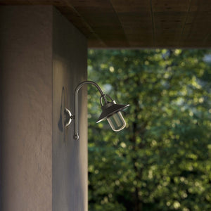 Outdoor brass wall lamp with curved arm protective hood and transparent glass diffuser rustic style Giada collection by Ghidini 1849 - Finish: OBR Dark Bronze