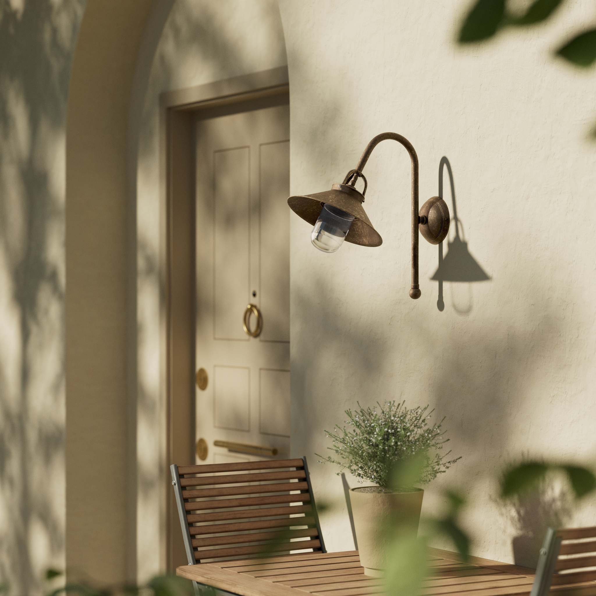 Country style outdoor brass wall lamp with arched arm protective hood and transparent glass diffuser Giada collection by Ghidini 1849 - Finish: OAS Antique Brass