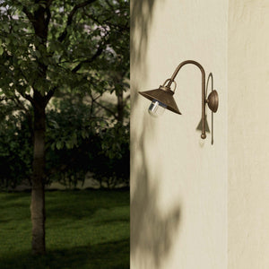Country style outdoor brass wall lamp with arched arm protective hood and transparent glass diffuser Giada collection by Ghidini 1849 - Finish: OAS Antique Brass