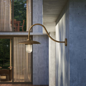 Vintage brass outdoor wall lamp with curved arm and protected glass by Ghidini 1849 - Finish: OAS Antique Brass
