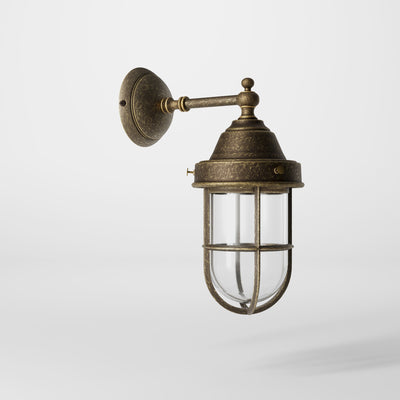 Outdoor wall lamp in brass with a transparent glass cage, industrial style, weather-resistant by Ghidini 1849 - Finish: OAS Antique Brass