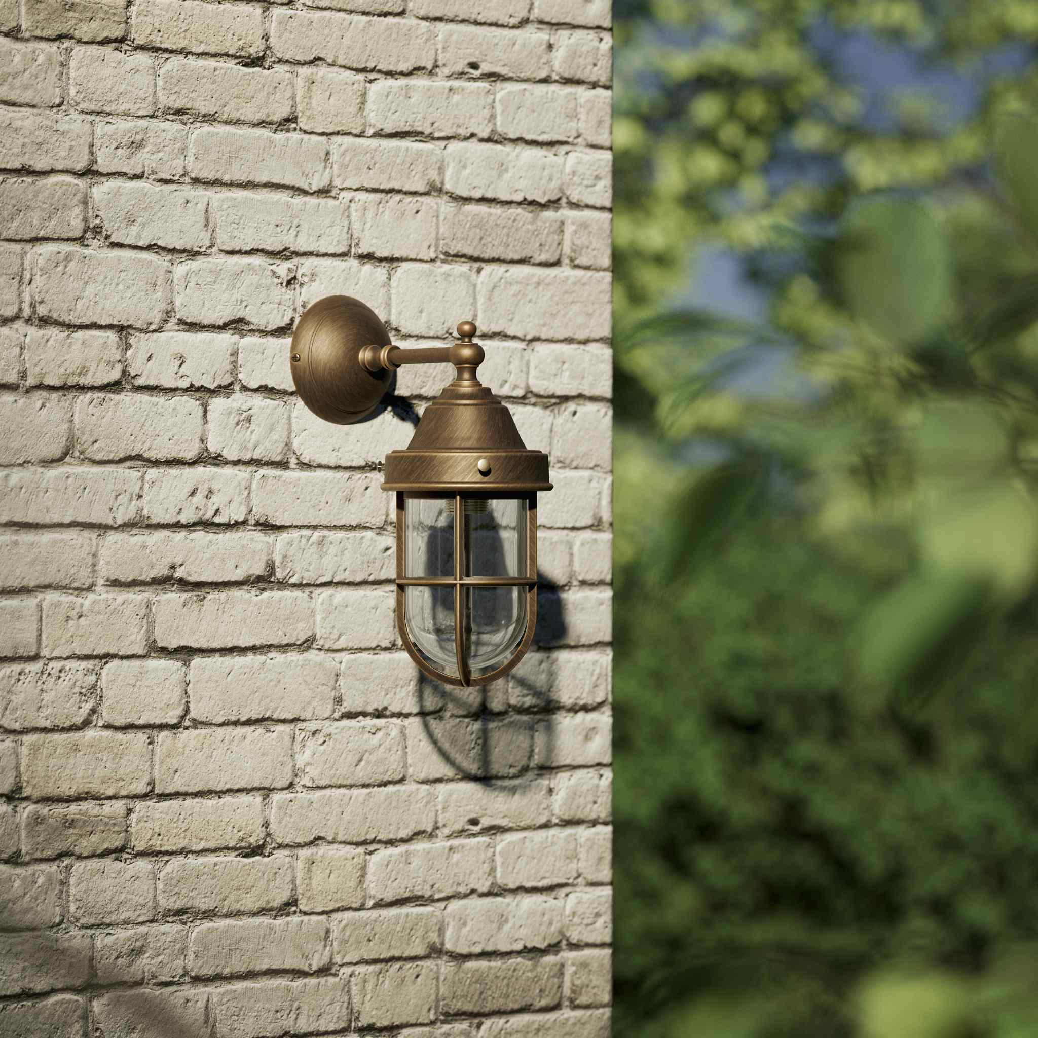 Outdoor wall lamp in brass with a transparent glass cage, industrial style, weather-resistant by Ghidini 1849 - Finish: OBM Bronze Satin Matt Brass