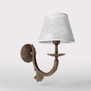 Classical brass wall lamp with decorated white fabric shade, curved arm and ornamental rosette, traditional floral details - Finish: OAS Antique Brass