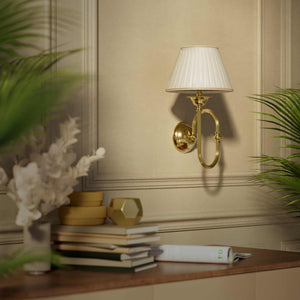 Classic brass wall lamp with curved arm and ivory pleated shade, design inspired by musical instruments Made in Italy by Ghidini 1849 - Finish: OLV Polished Brass