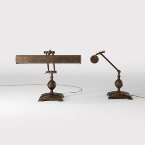 Executive brass desk lamp with cylindrical shade and dual articulation points mounted on decorative square base with spherical accent by Ghidini 1849 - Finish: OAS Antique Brass
