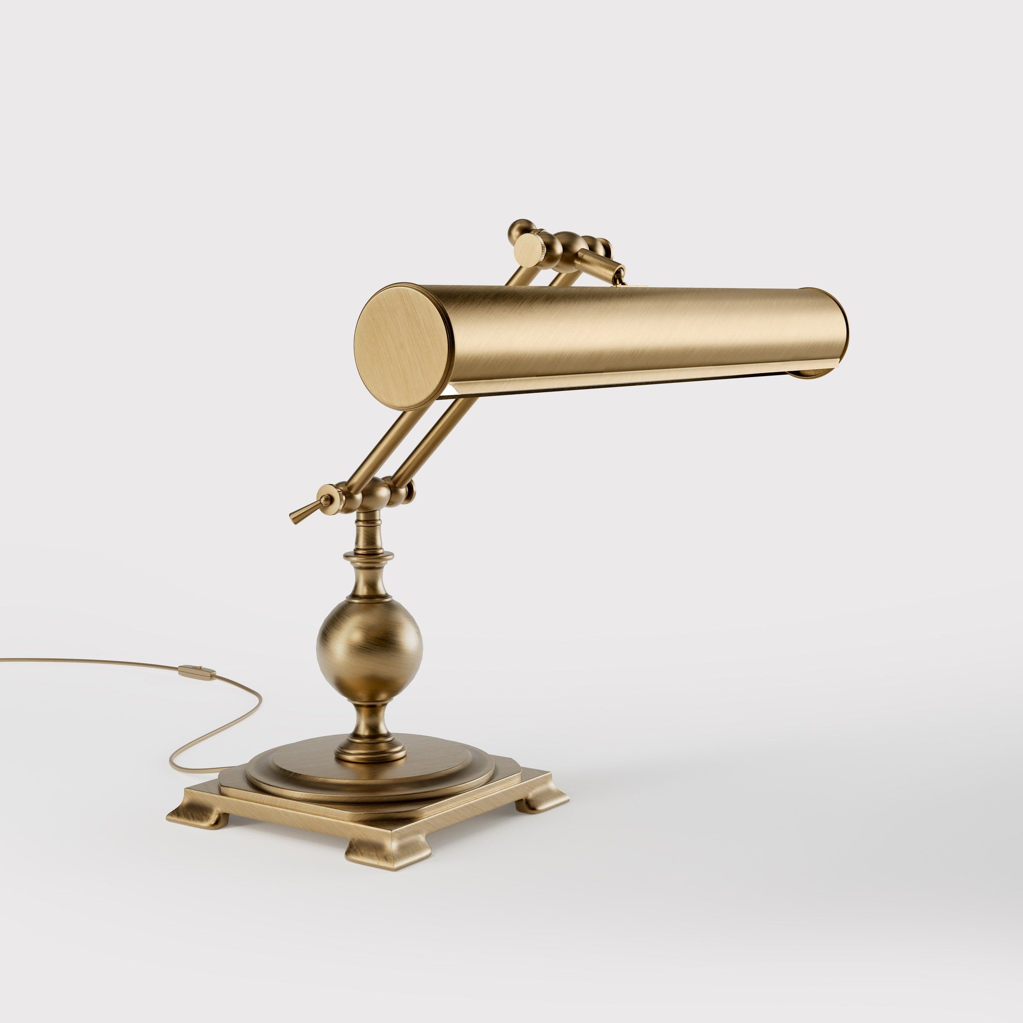 Executive brass desk lamp with cylindrical shade and dual articulation points mounted on decorative square base with spherical accent by Ghidini 1849 - Finish: OBS Bronze Satin Brass