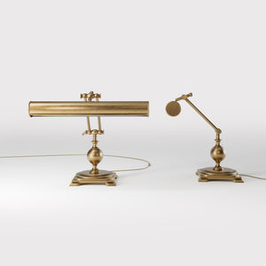 Executive brass desk lamp with cylindrical shade and dual articulation points mounted on decorative square base with spherical accent by Ghidini 1849 - Finish: OBS Bronze Satin Brass
