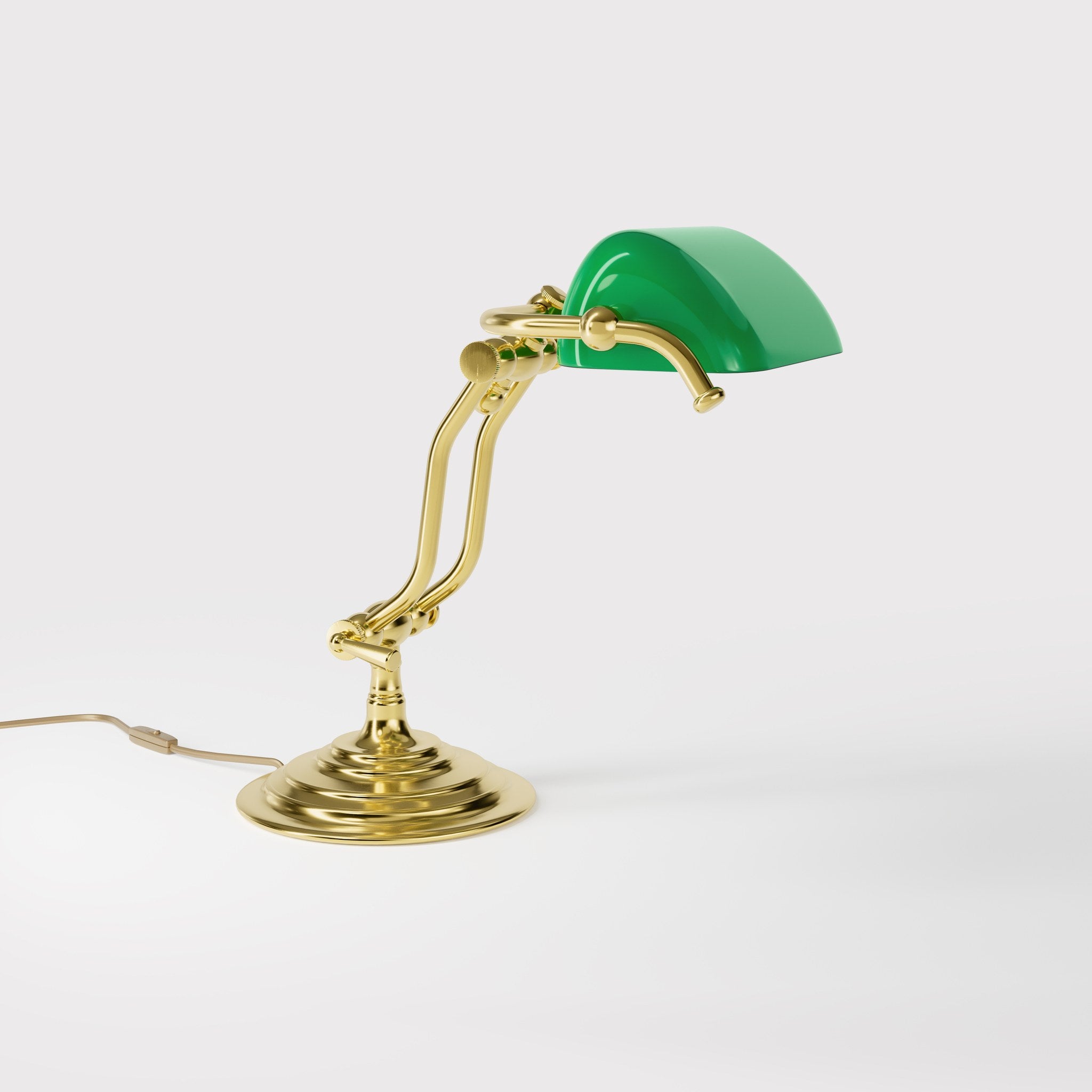 Compact brass desk lamp with green glass shade double joint system and stepped circular base by Ghidini 1849 - Finish: OLV Polished Brass