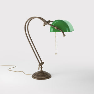 Classic banker's desk lamp with green glass shade and adjustable brass structure featuring dual joints and pull chain switch by Ghidini 1849 - Finish: OAS Antique Brass