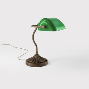 Art Deco desk lamp with green glass shade shell-shaped brass base with decorated design and sinuous stem by Ghidini 1849 - Finish: OAS Antique Brass