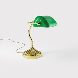 Art Deco desk lamp with green glass shade shell-shaped brass base with decorated design and sinuous stem by Ghidini 1849 - Finish: OLV Polished Brass