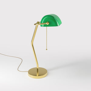 Minimalist table lamp with green glass shade circular brass base slender stem and pull chain by Ghidini 1849 - Finish: OLV Polished Brass