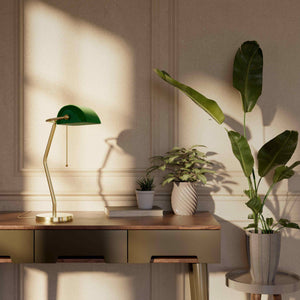 Minimalist table lamp with green glass shade circular brass base slender stem and pull chain by Ghidini 1849 - Finish: OLV Polished Brass
