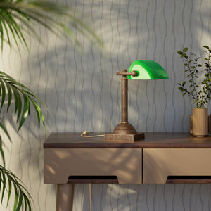Compact banker's lamp with green glass shade and brass structure, square base and essential design by Ghidini 1849 - Finish: OAS Antique Brass