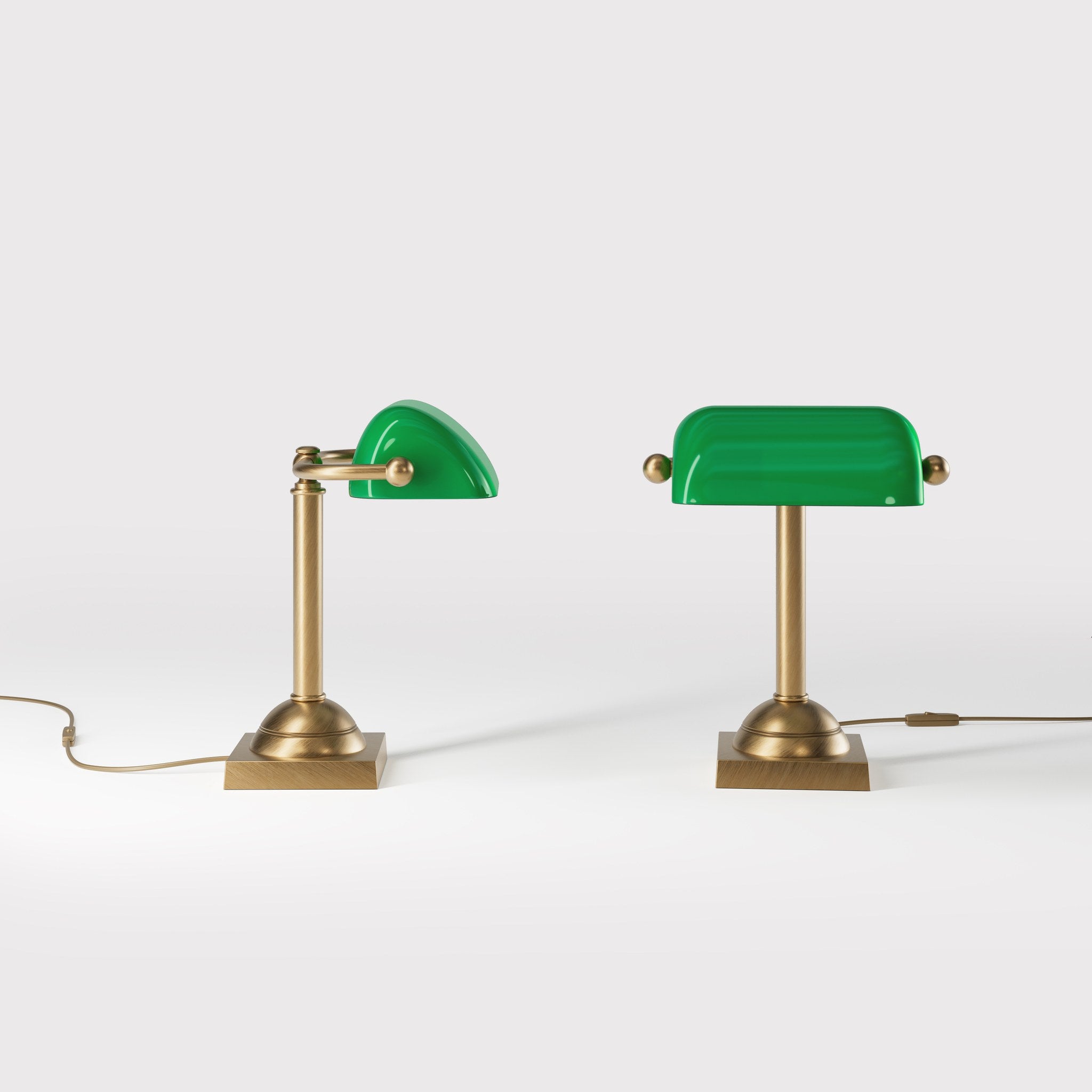 Compact banker's lamp with green glass shade and brass structure, square base and essential design by Ghidini 1849 - Finish: OBS Bronze Satin Brass