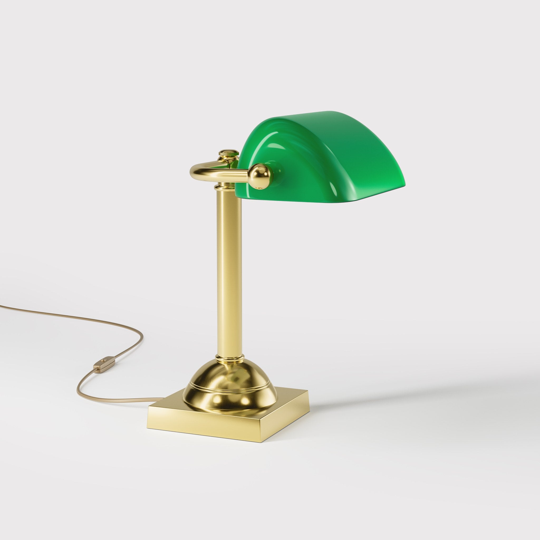 Compact banker's lamp with green glass shade and brass structure, square base and essential design by Ghidini 1849 - Finish: OLV Polished Brass
