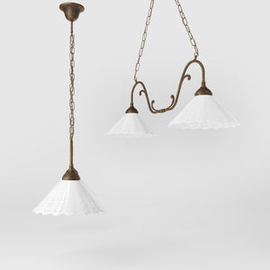 Art Nouveau pendant lamp with two pierced white ceramic shades, decorative brass arms and adjustable suspension chain by Ghidini 1849 - Finish: OAS Antique Brass