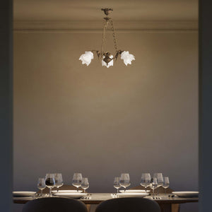 Art Nouveau chandelier with dancing brass putti and three frosted glass shades, decorated chains, floral motif rosette by Ghidini 1849 - Finish: OAS Antique Brass