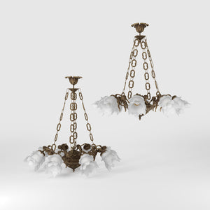 Art Nouveau chandelier with eight dancing brass putti, petal-shaped frosted glass shades, decorated chains and floral rosette by Ghidini 1849 - Finish: OAS Antique Brass
