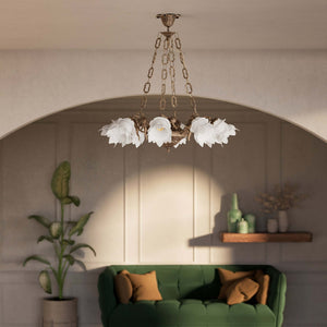 Art Nouveau chandelier with eight dancing brass putti, petal-shaped frosted glass shades, decorated chains and floral rosette by Ghidini 1849 - Finish: OAS Antique Brass