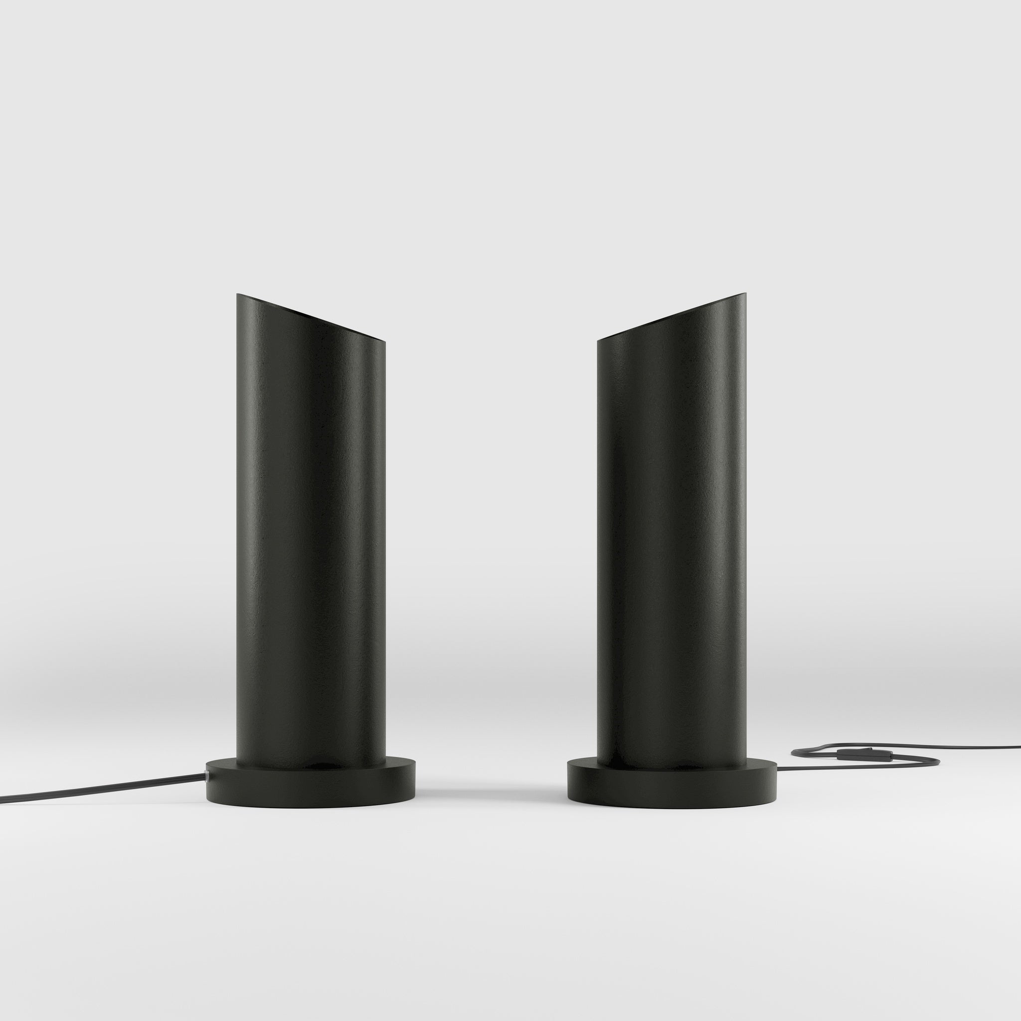 Brass table lamp with a sleek cylindrical shape and circular base, ideal for contemporary and elegant interiors by Ghidini 1849 - Finish: ONO Matt Black