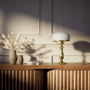 Art Deco table lamp with glossy white mushroom glass shade, sculpted brass base with undulating motifs, Italian design by Ghidini 1849 - Finish: OLV Polished Brass